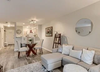 Living and dining room area with chandelier and hardwood floors at 2530 15th Ave W #508 Seattle WA 98119