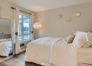 Bedroom with hardwood floors and outside view of city at 2530 15th Ave W #508 Seattle WA 98119