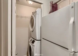 Utility room closet with stacked washer/dryer directly off kitchen at 2530 15th Ave W #508 Seattle WA 98119