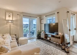 Livingroom area with slider access to balcony and hardwood floors at 2530 15th Ave W #508 Seattle WA 98119