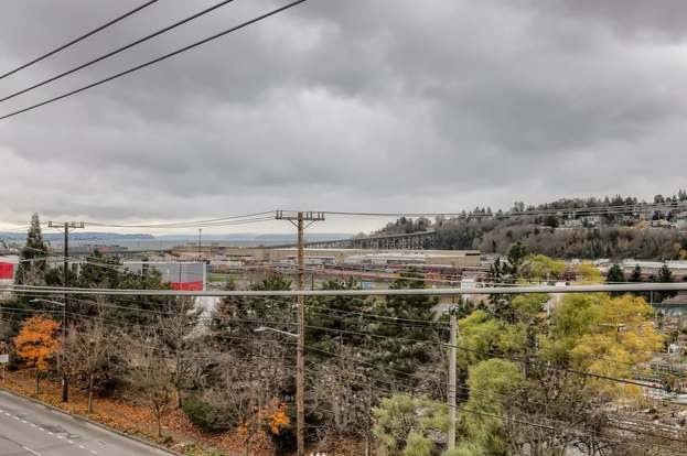 Balcony view of trees and hills at 2530 15 Ave W #508 Seattle WA 98119