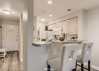 High counter seating area on kitchen and hallway leading to front door at 2530 15th Ave W Seattle WA 98119