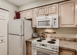 Kitchen appliances - refrigerator, range and overhead microwave at 2530 15th Ave W #508 Seattle WA 98119