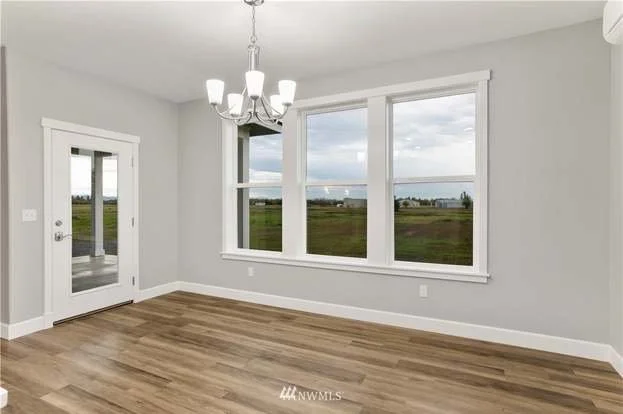 Dining room with three large windows and backdoor at 112 Skyhawk Dr Toledo WA 98591