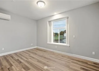 Bedroom with window and hardwood floors at 112 Skyhawk Dr Toledo WA 98591