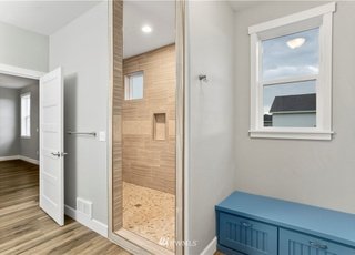 Bathroom walk-in shower, window and storage bench at 112 Skyhawk Dr Toledo WA 98591