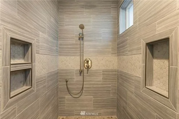 Bathroom walk in shower with storage nooks on both sides at 112 Skyhawk Dr Toledo WA 98591