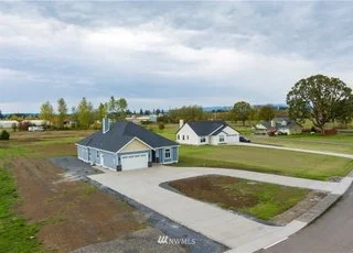 View of home and U shaped driveway from street at 112 Skyhawk Dr Toledo WA 98591
