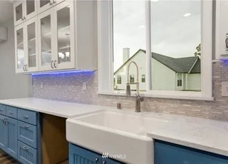 Kitchen sink with upper and lower cupboards and window at 112 Skyhawk Dr Toledo WA 87591
