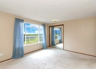 Bedroom with large windows and low pile carpeting at 21700 Calhoun Road Monroe, WA 98272