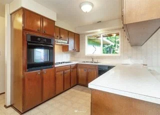 Kitchen with upper and lower cabinets, window and tiled floors at 21700 Calhoun Road Monroe, WA 98272
