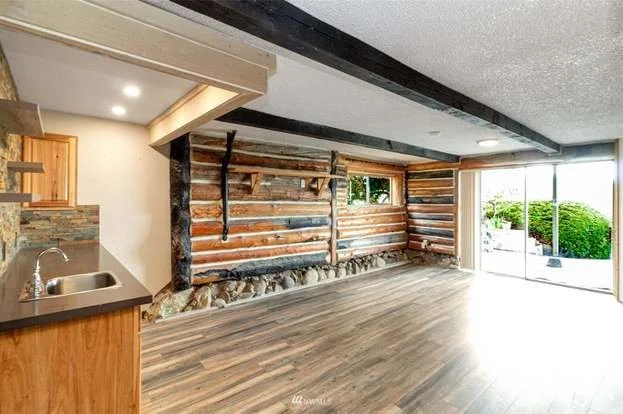 Livingroom with built in wet bar, hardwood floors and double sliding doors at 21700 Calhoun Road Monroe, WA 98272