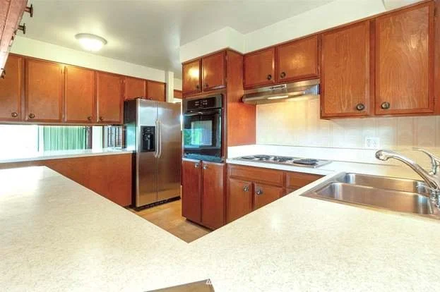 Kitchen with upper and lower cabinets, tiled floors and well lit work areas at 21700 Calhoun Road Monroe, WA 98272