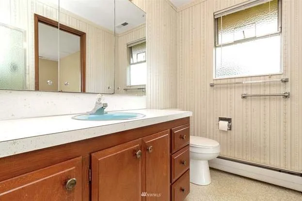 Bathroom with window, tiled floors and long vanity with cabinets and drawers at 21700 Calhoun Road Monroe, WA 98272