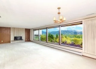 The great room with wall of windows and fireplace at 21700 Calhoun Road Monroe, WA 98272