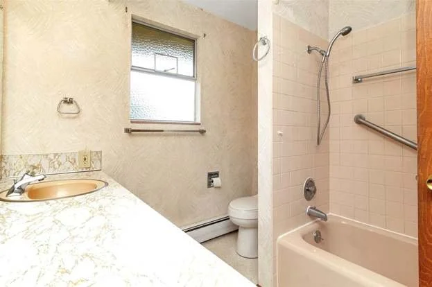 Bathroom with tub/shower combo, grab bars and window at 21700 Calhoun Road Monroe, WA 98272
