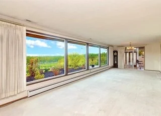 The great room with wall of windows providing stunning views at 21700 Calhoun Road Monroe, WA 98272