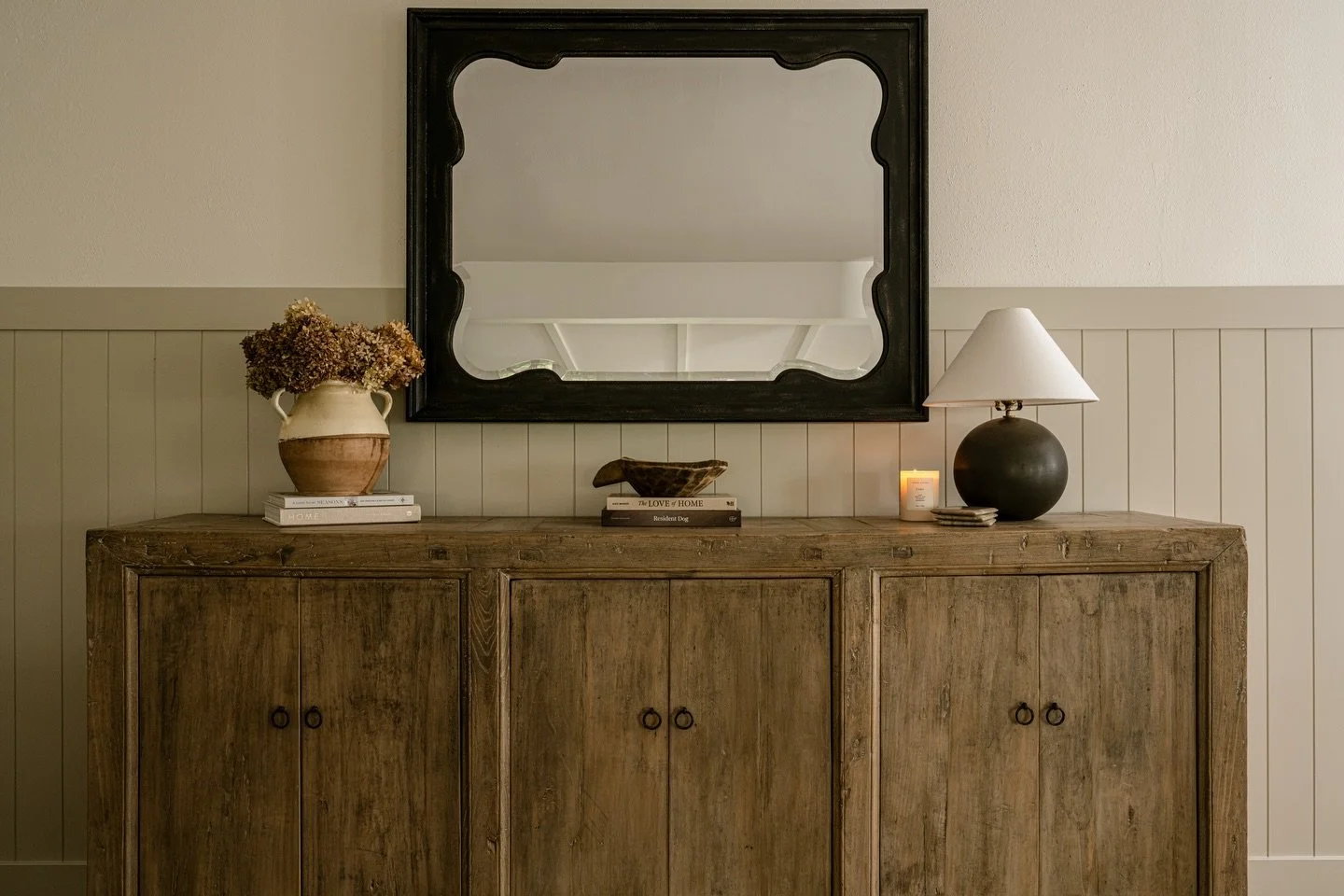 It is these little moments that quietly turn a house into a HOME. Storage, but make it a stylish sideboard. A candle burning that smells like the season and lifts the whole mood. A stack of books that are there to be read, flipped through, and look g