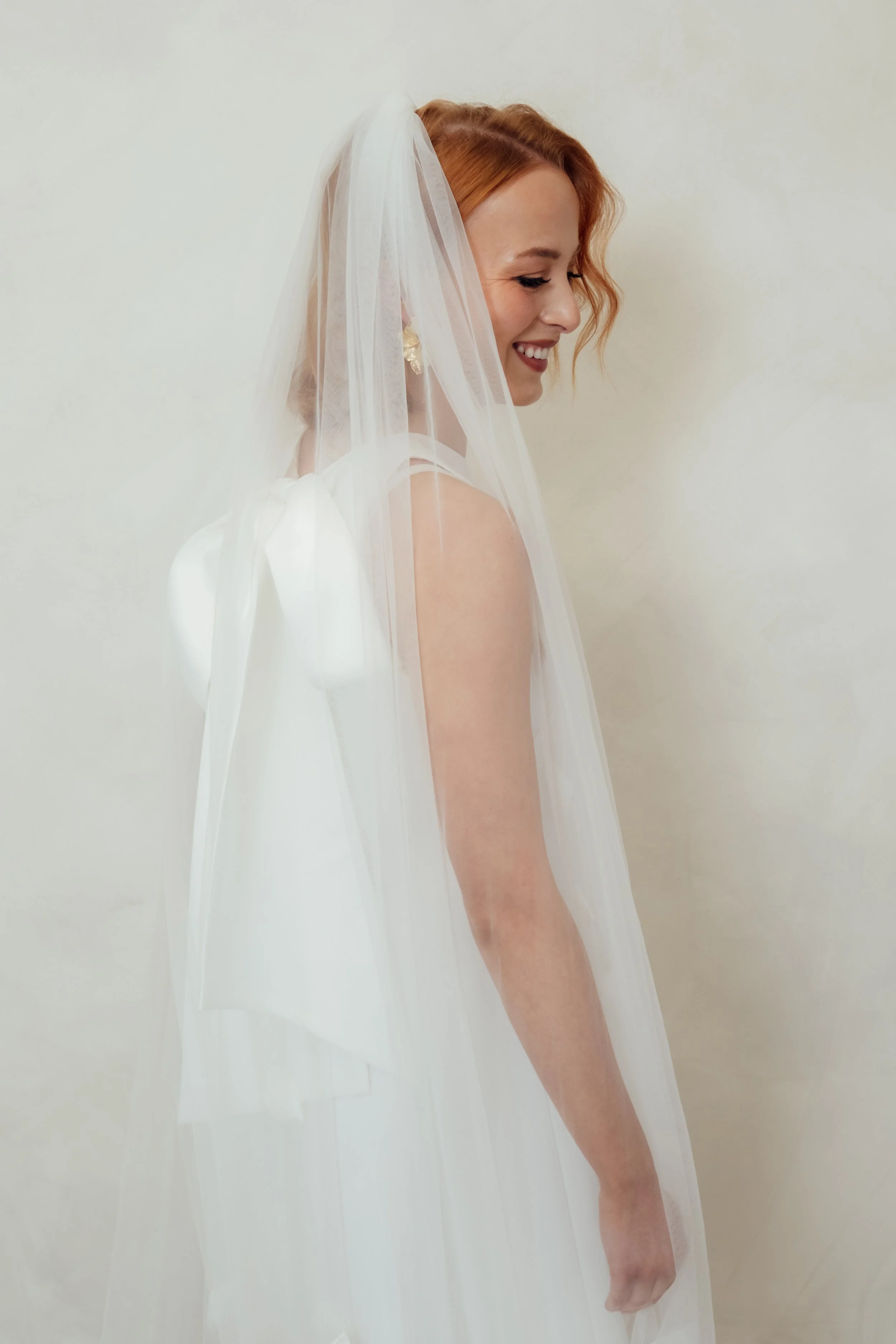 Model Genevieve wearing The Charlie Veil in soft Italian tulle, a plain lightweight bridal veil with a natural drape