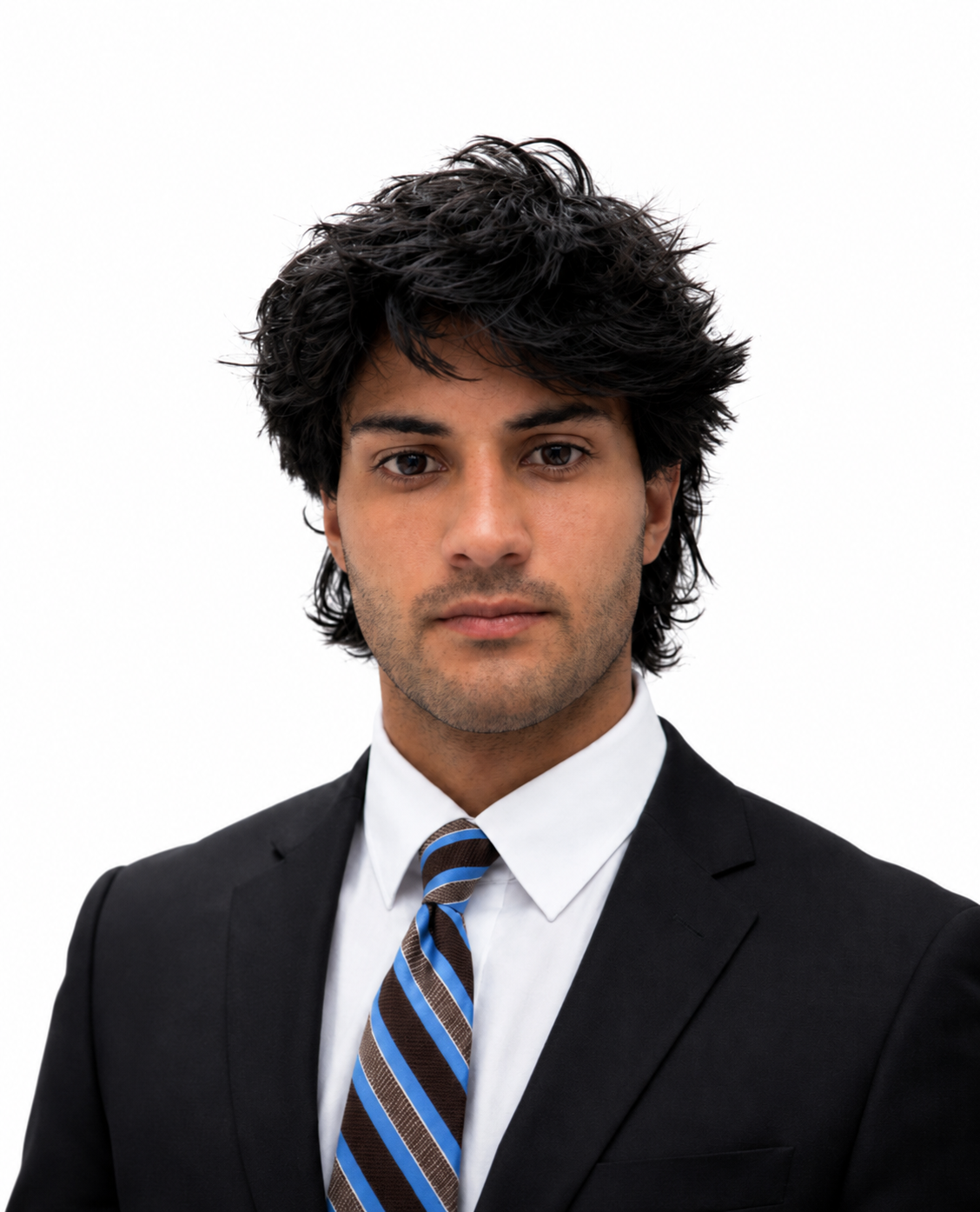 Portrait of a young man with dark, wavy hair wearing a black suit, white shirt, and striped blue, brown, and white tie against a plain white background.