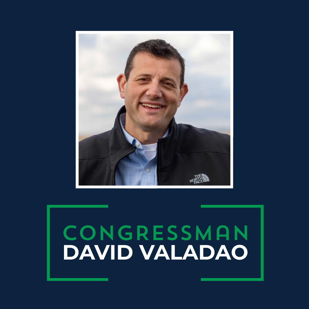 Photograph of Congressman David Valadao smiling outdoors, wearing a black North Face jacket over a blue shirt, with a cloudy sky in the background.