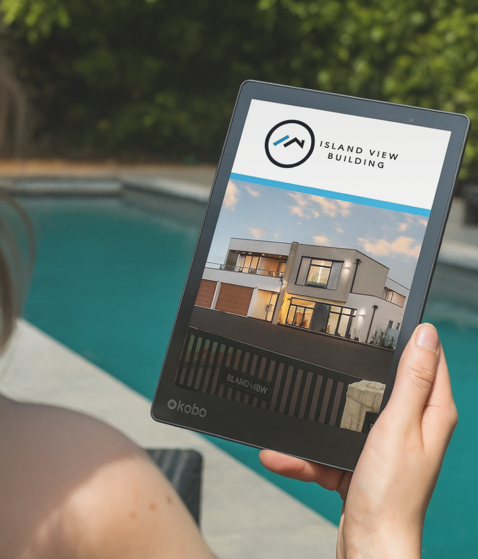 A tablet displaying an architectural rendering of a modern house, held by a person near a swimming pool with a blurred background of trees.