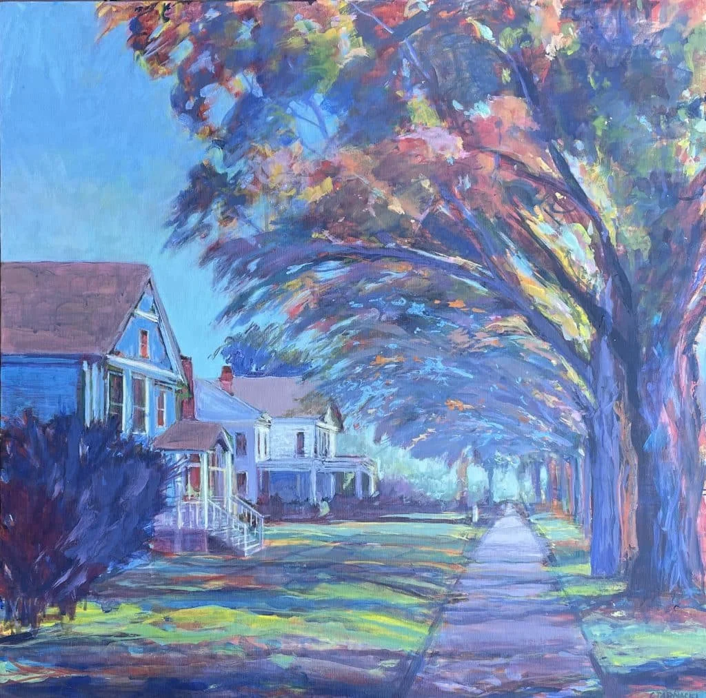 An impressionistic painting of a tree-lined street with houses on the left. The trees have multicolored foliage and arch over the sidewalk, creating a canopy. The scene appears to depict a peaceful residential neighborhood during autumn day.