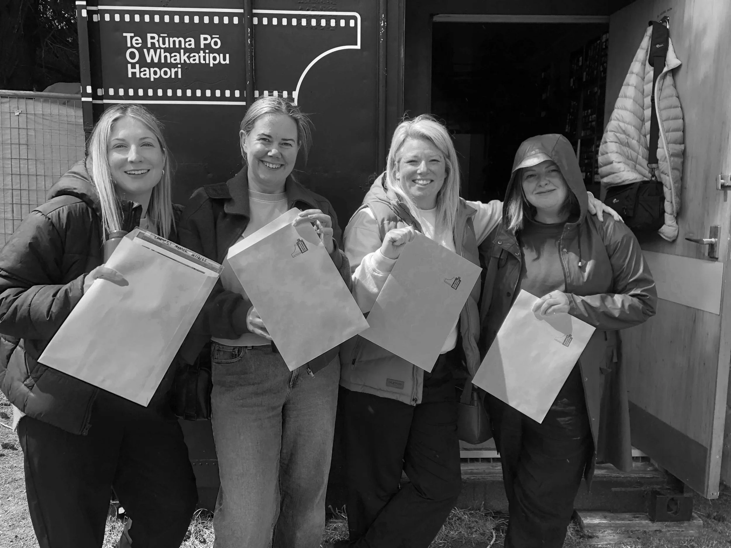 4 women holding their photo prints outside the Queenstown Darkroom