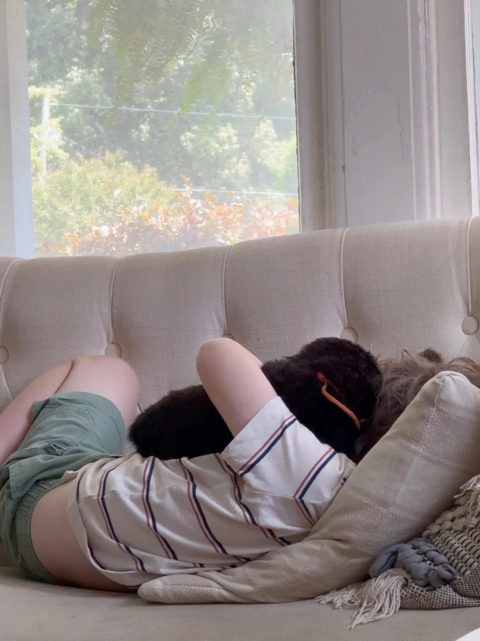 This child is never happier than when he&rsquo;s got pups to love on. His arms are never empty.
