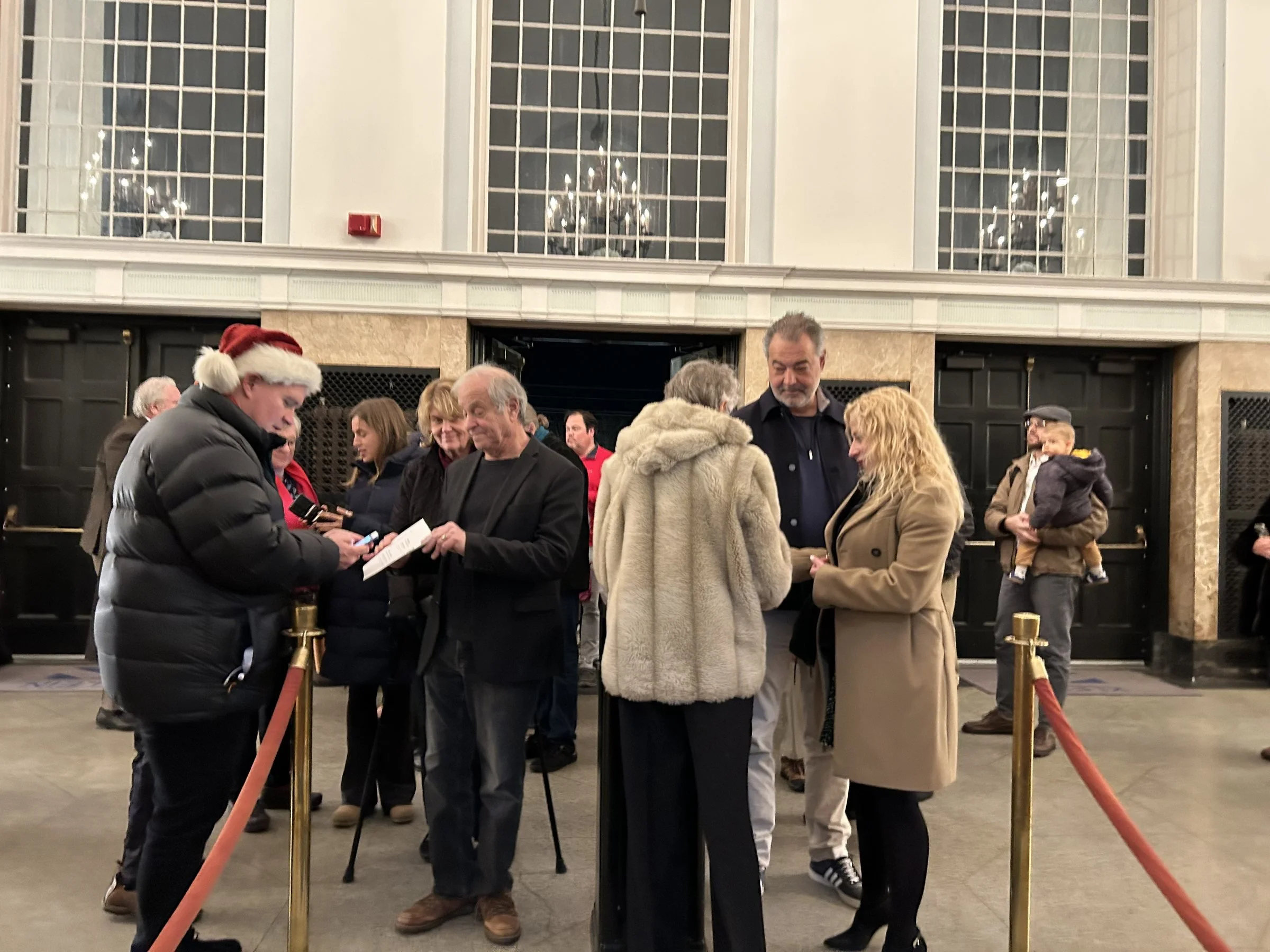 Concertgoers arriving in the lobby of the Klein Memorial Auditorium