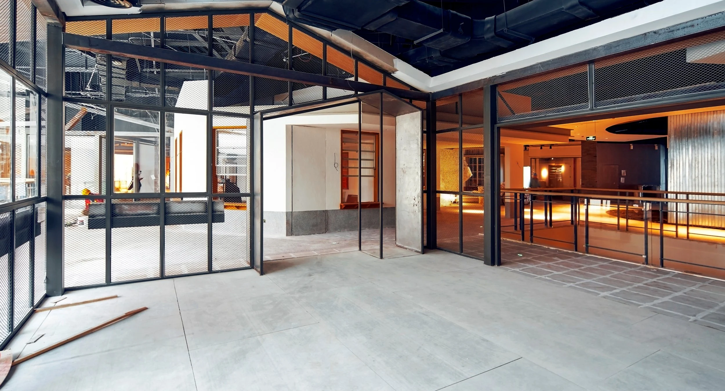 Interior construction site with metal framing and unfinished walls, with some construction tools and materials on the floor. Construction Consulting Owners Representation