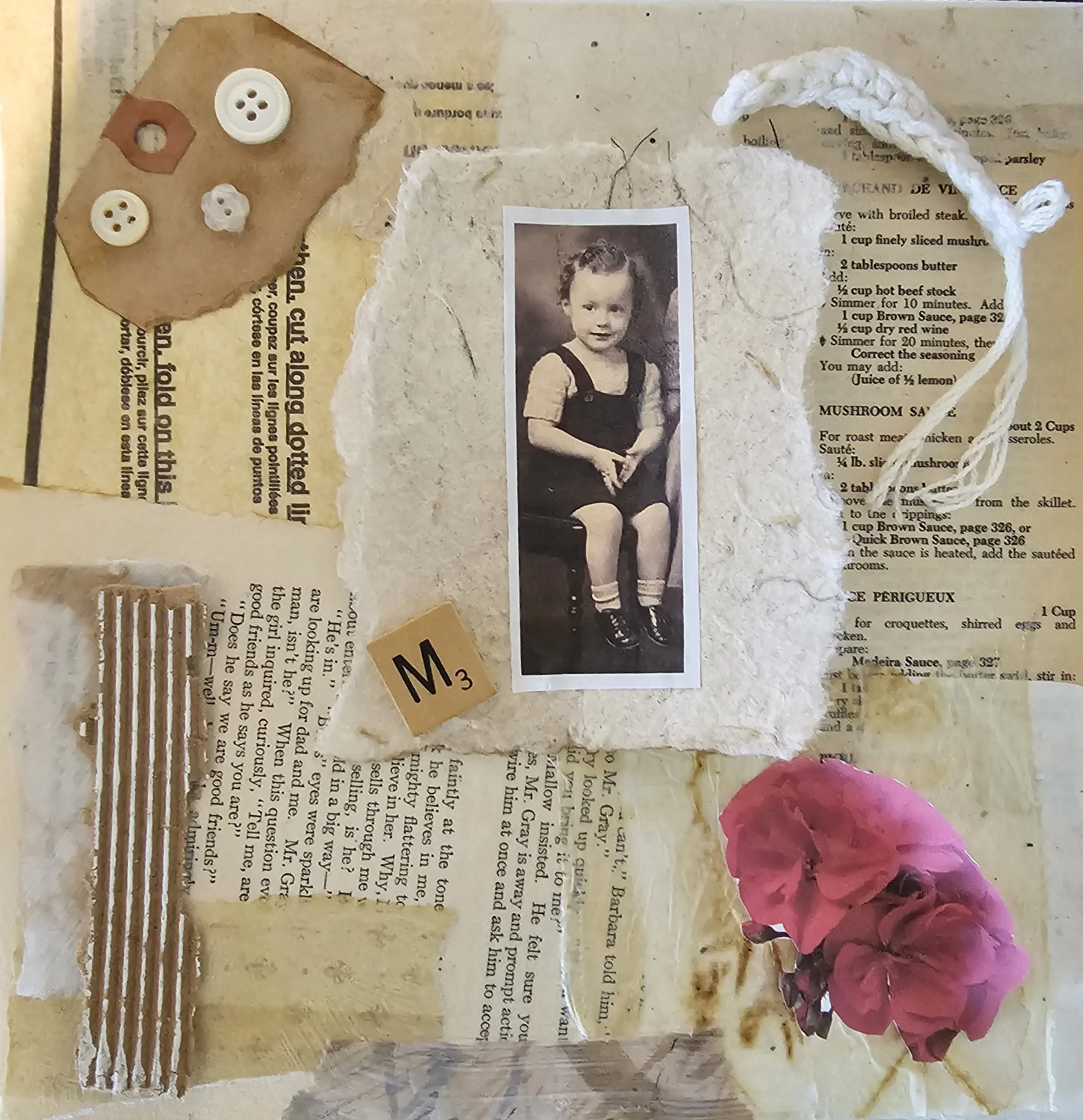 A collage including a black and white photograph of a young girl, pieces of torn and aged handwritten and printed paper, a small strip of ribbed fabric, a pink flower, a small square tile with the letter 'M' and a number three, a piece of textured wh