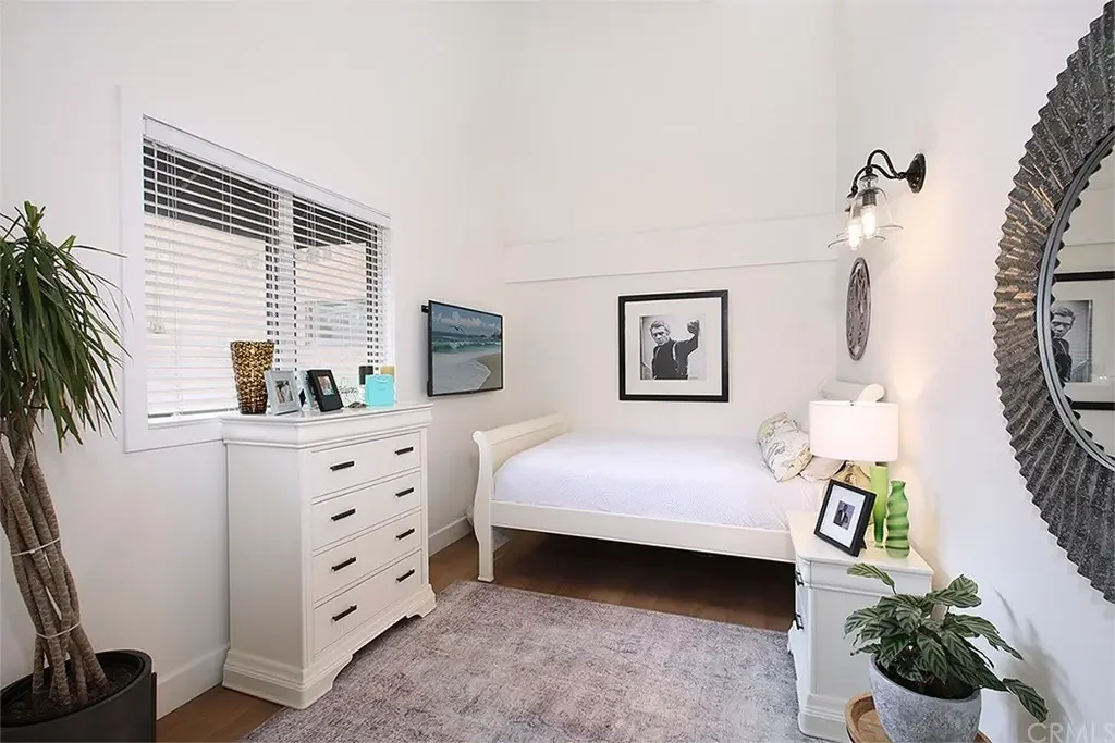 After: brightened room with white paint and added wall lighting. New window blinds.