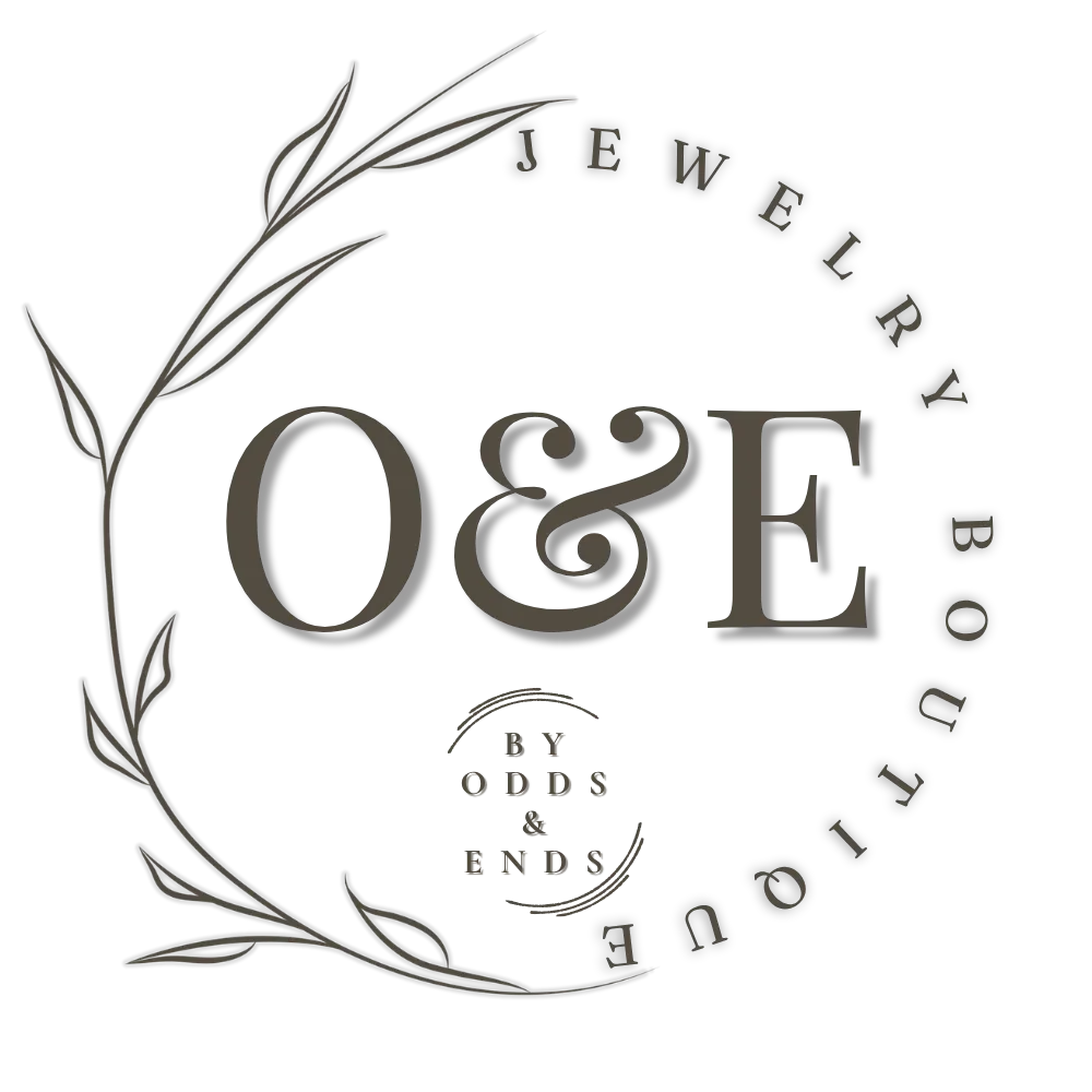 Jewelry brand logo with the initials O&E, surrounded by a decorative leaf design and the text "Jewelry by Odds & Ends".