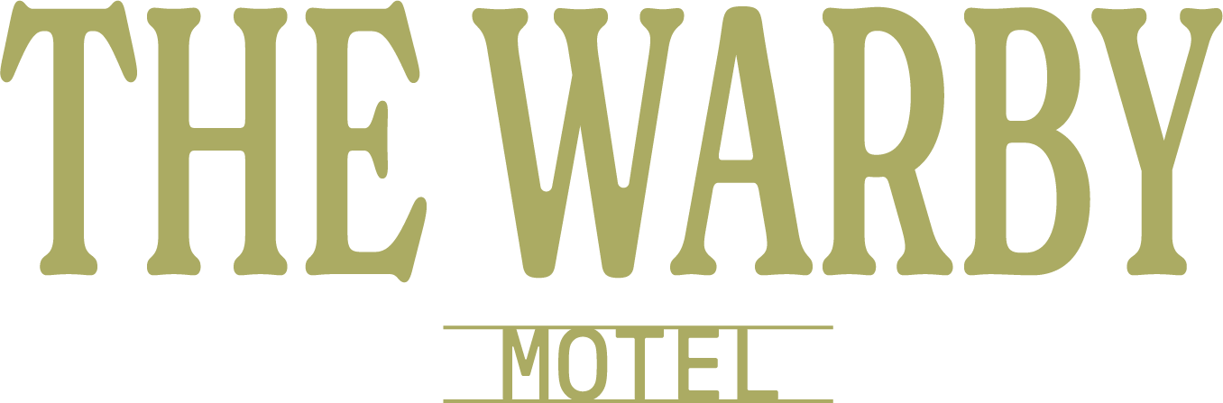 Logo of The Warby Motel with large, stylized text and smaller text underneath, likely representing a motel branding.