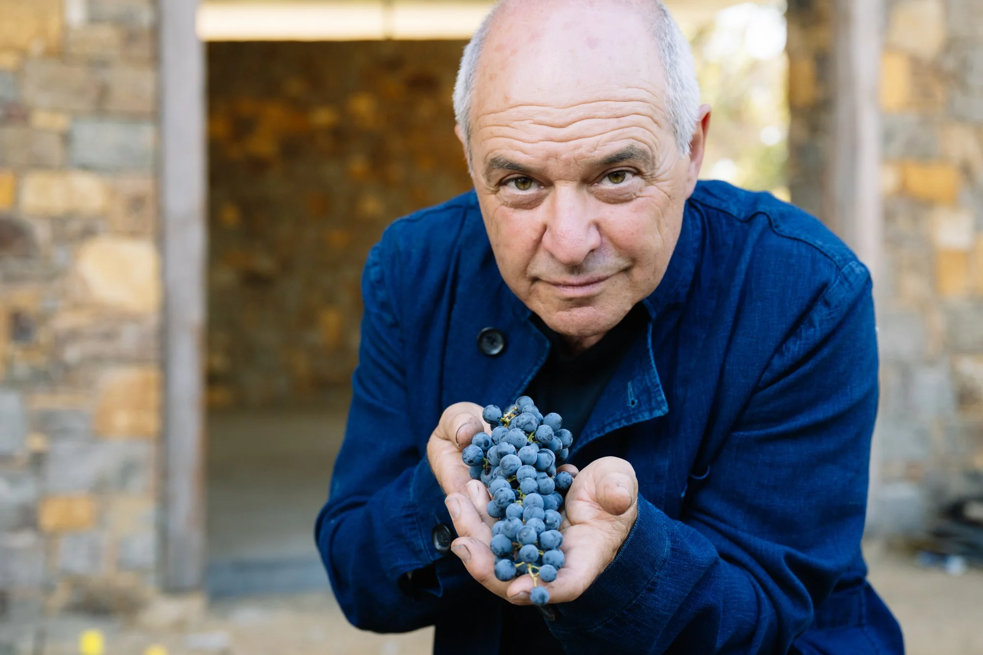 Will Berliner in the winery with red grapes.jpg