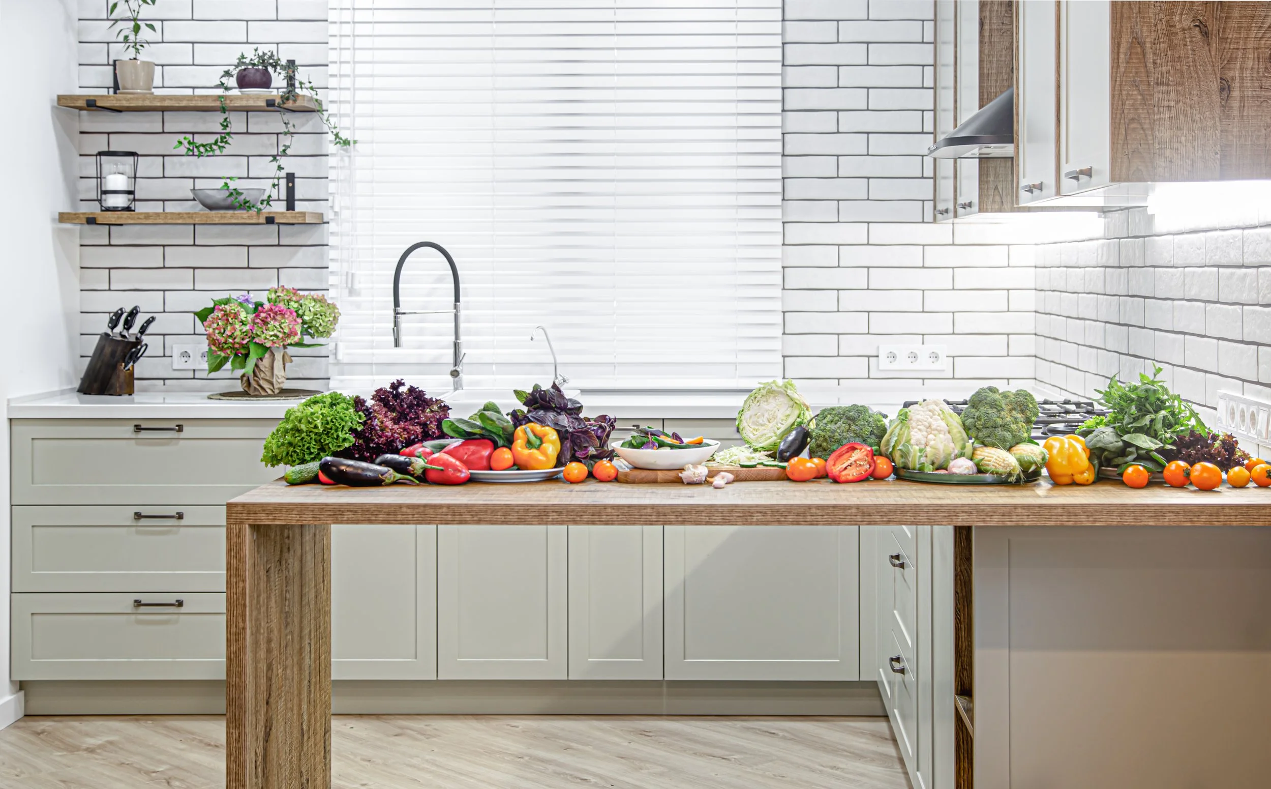 various-vegetables-wooden-table-against-background-modern-kitchen-interior.jpg