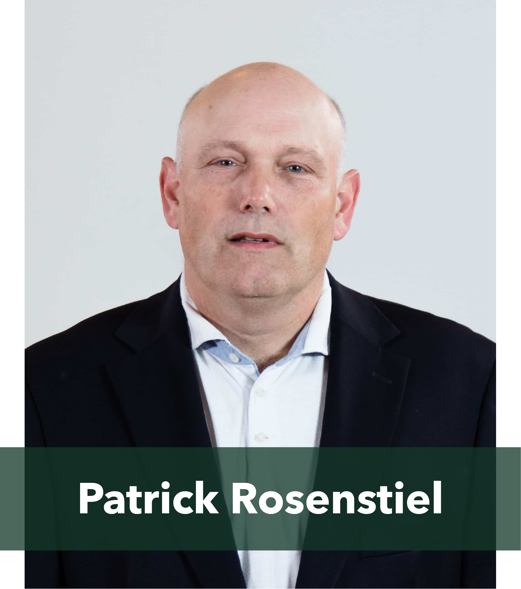 Headshot of Patrick Rosenstiel wearing a suit and white shirt, looking directly at the camera with a neutral expression.