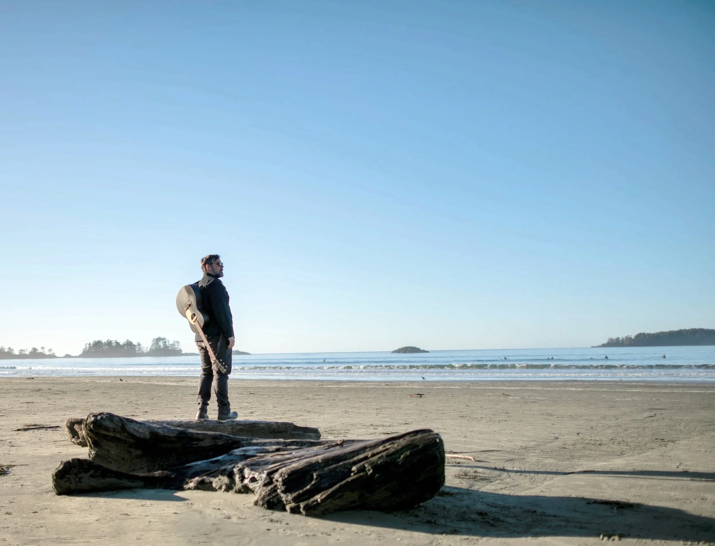 Vancouver Island Wedding Musician standing on the beach in Tofino, BC for live vocal and acoustic guitar for weddings.