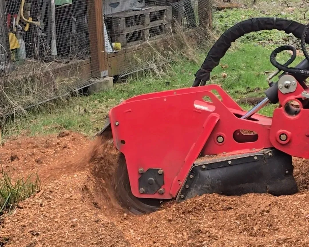 Red tiller rotating in soil, cultivating the ground in a garden or farm.