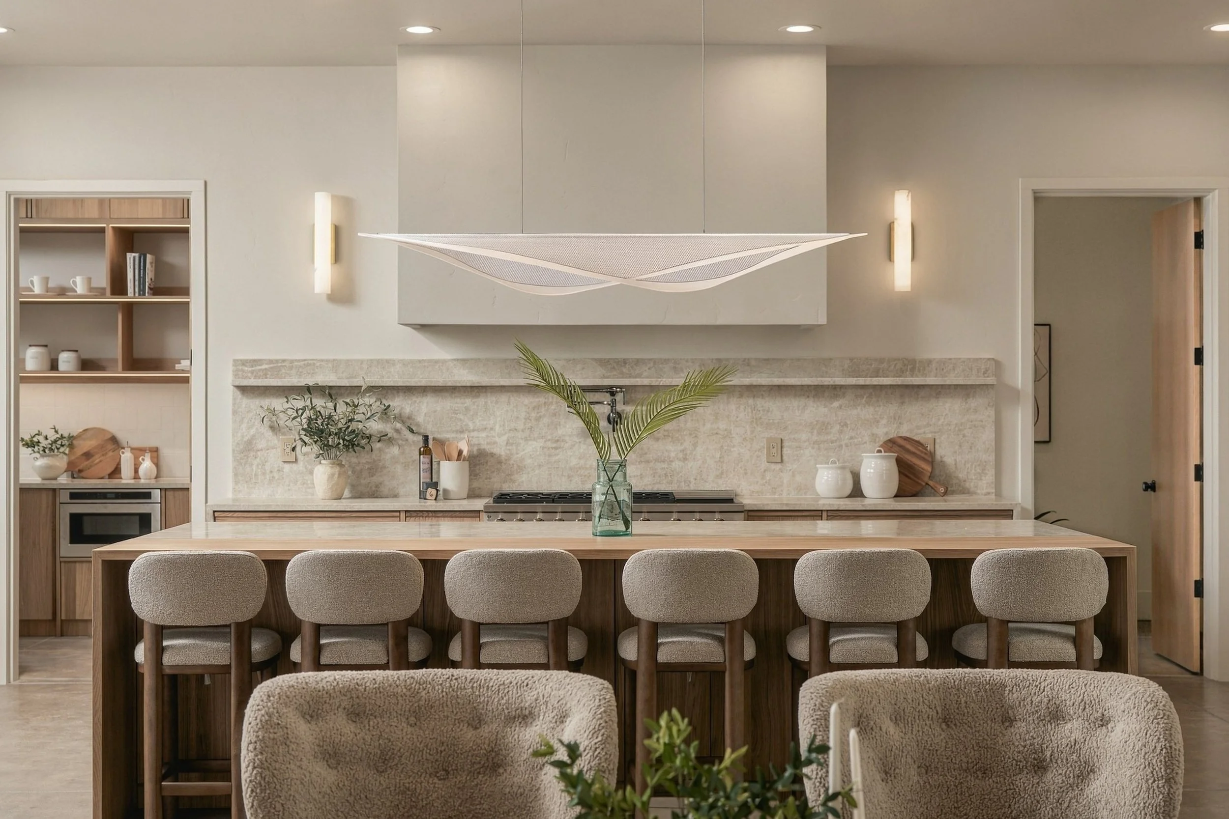 Kitchen with a plaster range hood, stone backsplash and long oak island