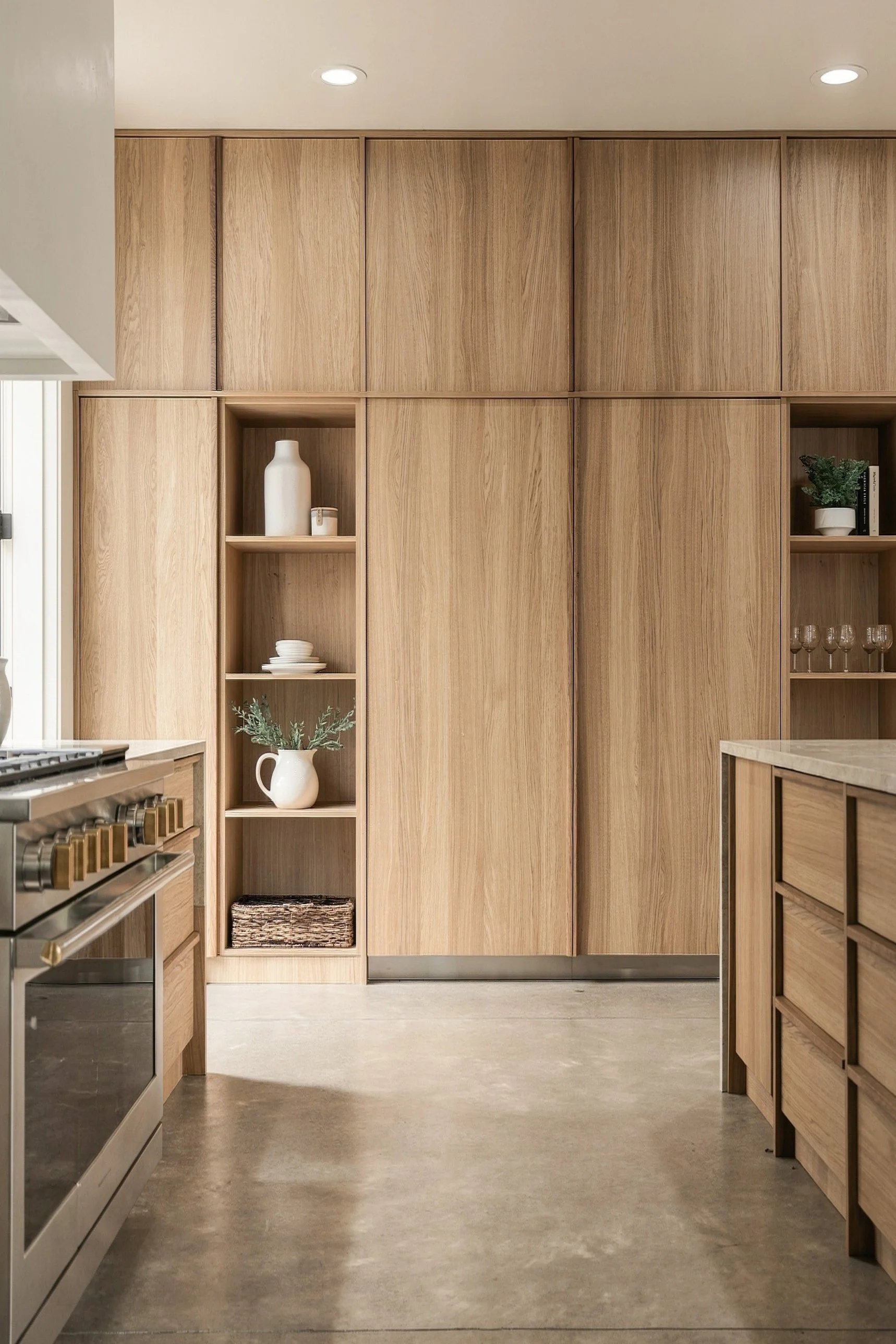 Full-height oak cabinet wall with open shelving