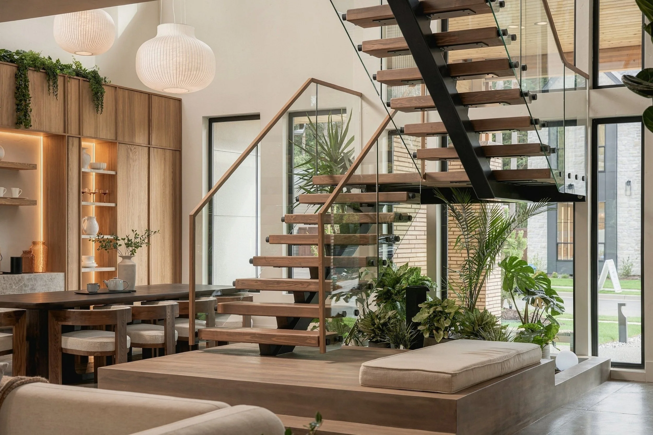 Floating stair above an indoor garden, with the dining room beyond