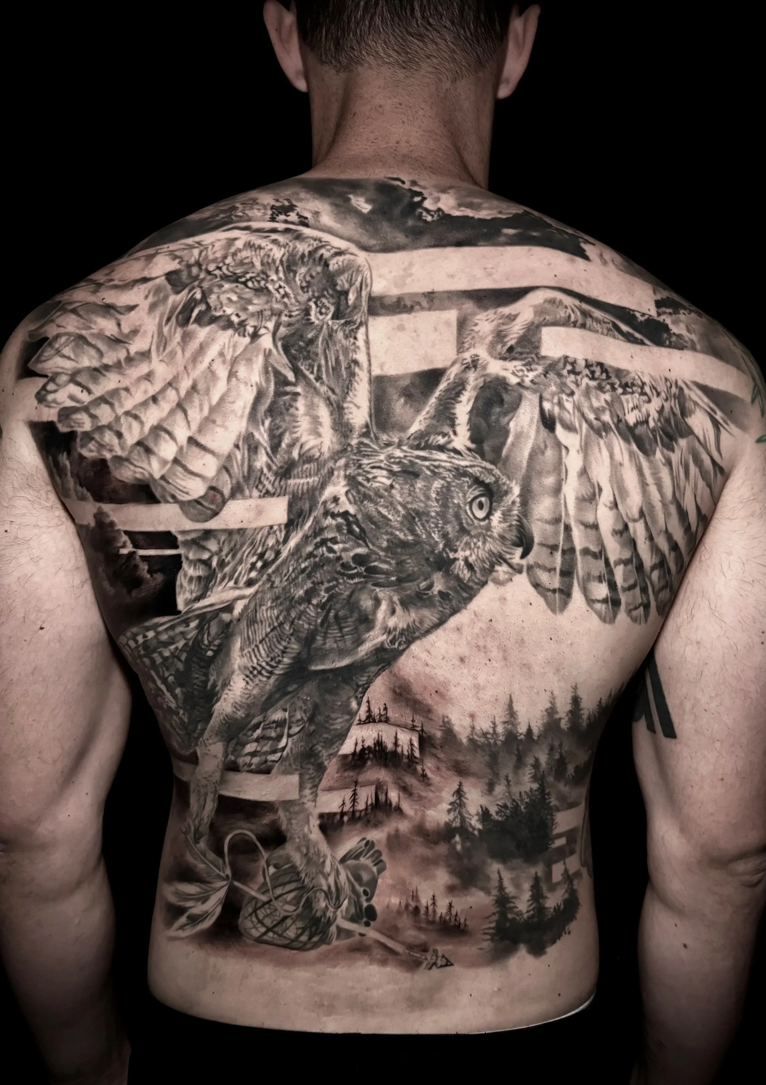 Innovative realistic black and grey backpiece tattoo owl and forest with graphic design integration In Los Angeles Area, at Outer Limits tattoo shop. by Jhon Gutti
