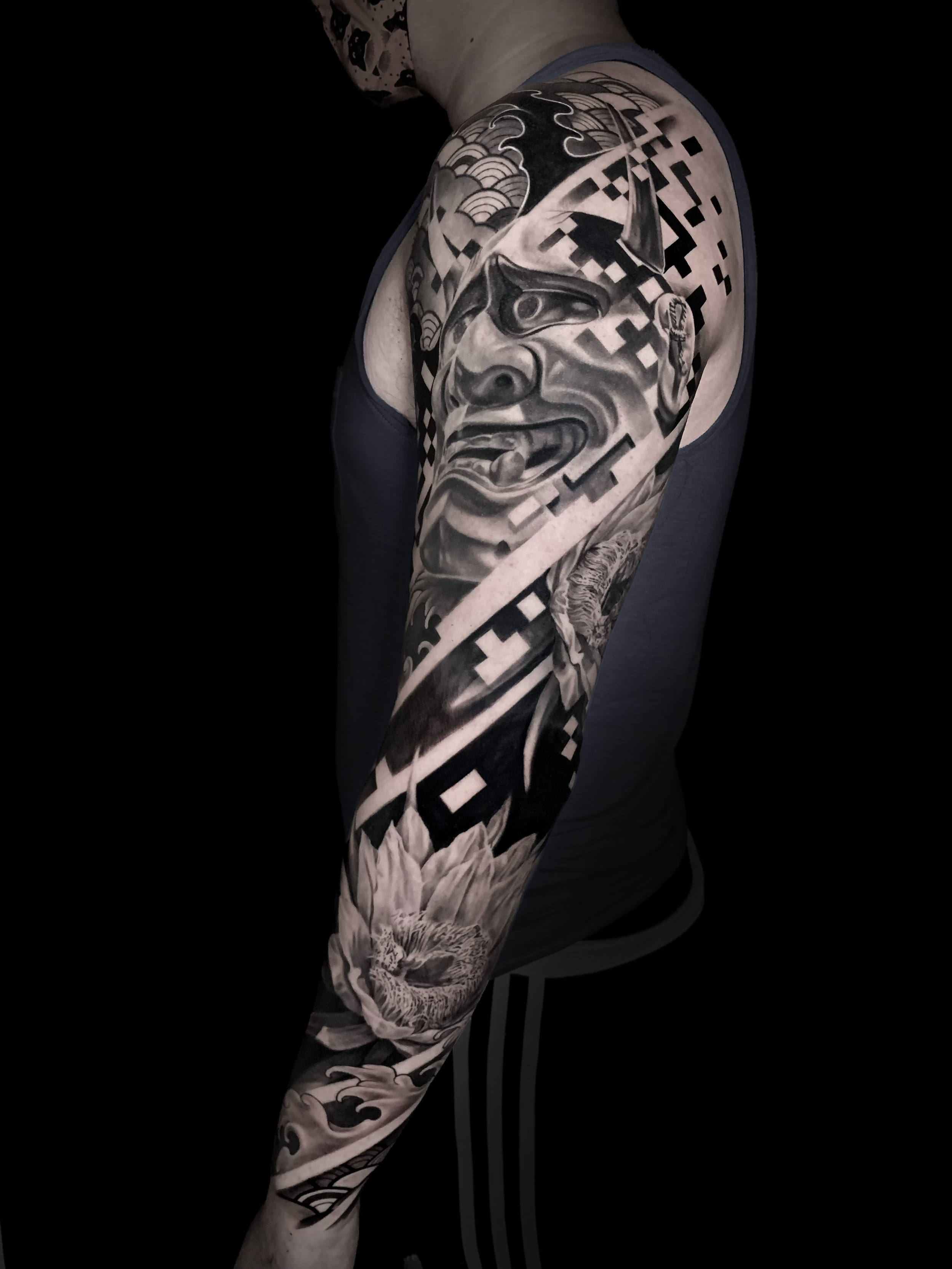 Innovative realistic black and grey Japanese tattoo Hanya Mask, Oni, Passion flower with graphic design pixels integration In Los Angeles Area, at Outer Limits tattoo shop. by Jhon Gutti