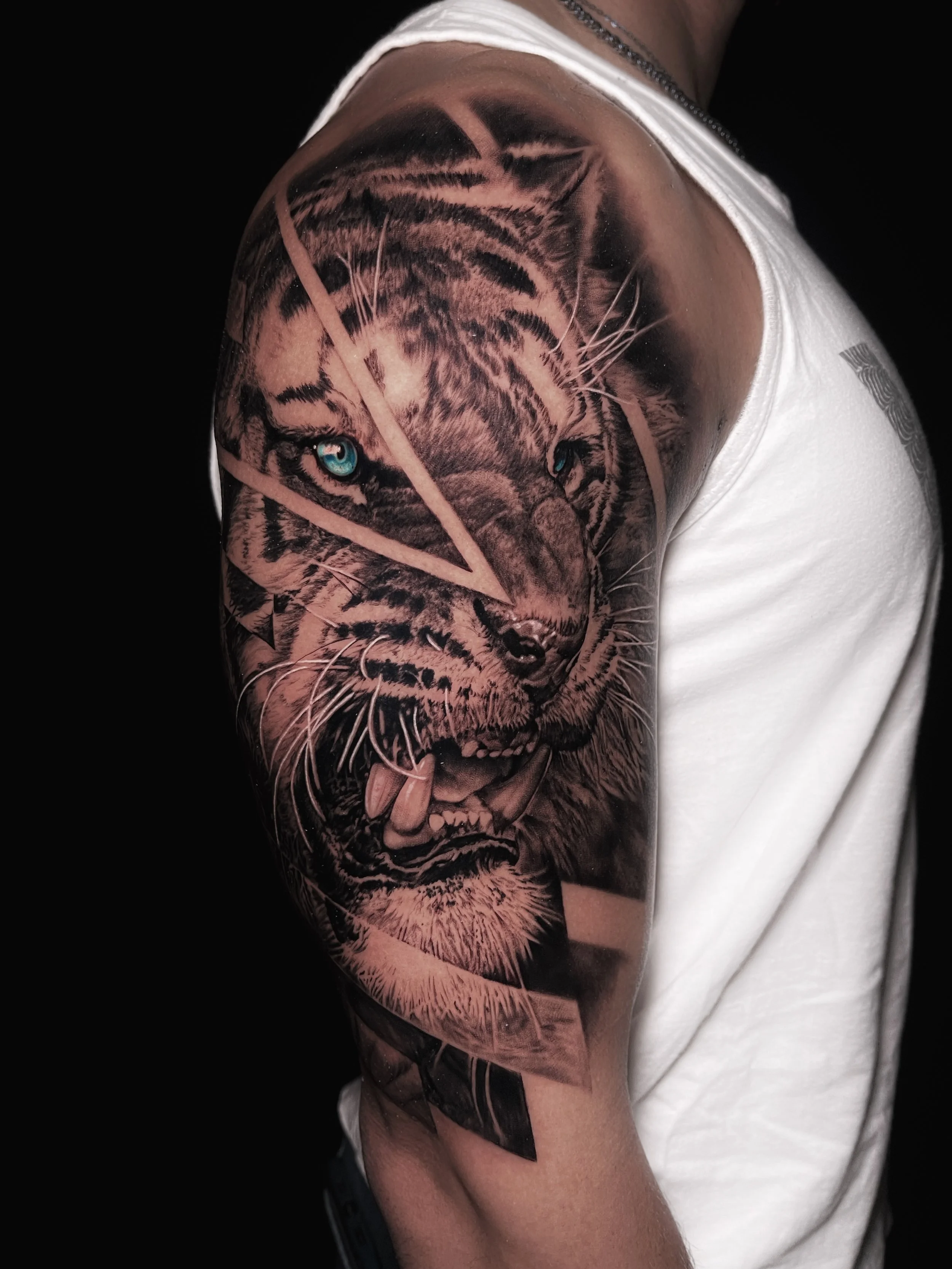 Innovative realistic black and grey tattoo Tiger with graphic design integration In Los Angeles Area, at Outer Limits tattoo shop. by Jhon Gutti