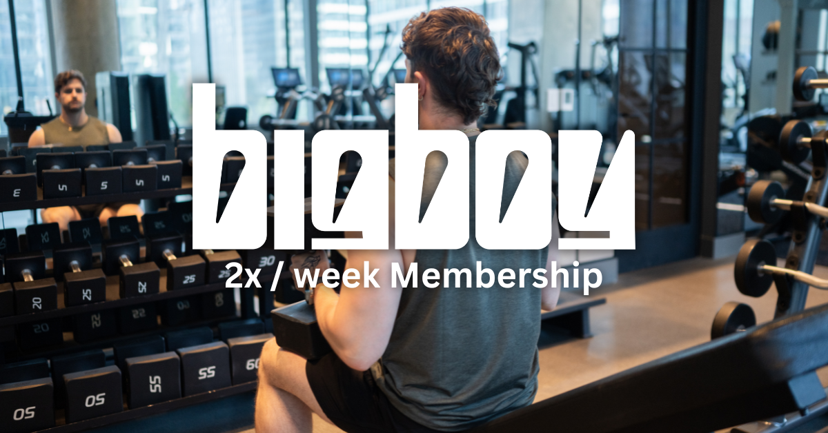 Two men working out at a gym with weight racks and exercise equipment in the background.