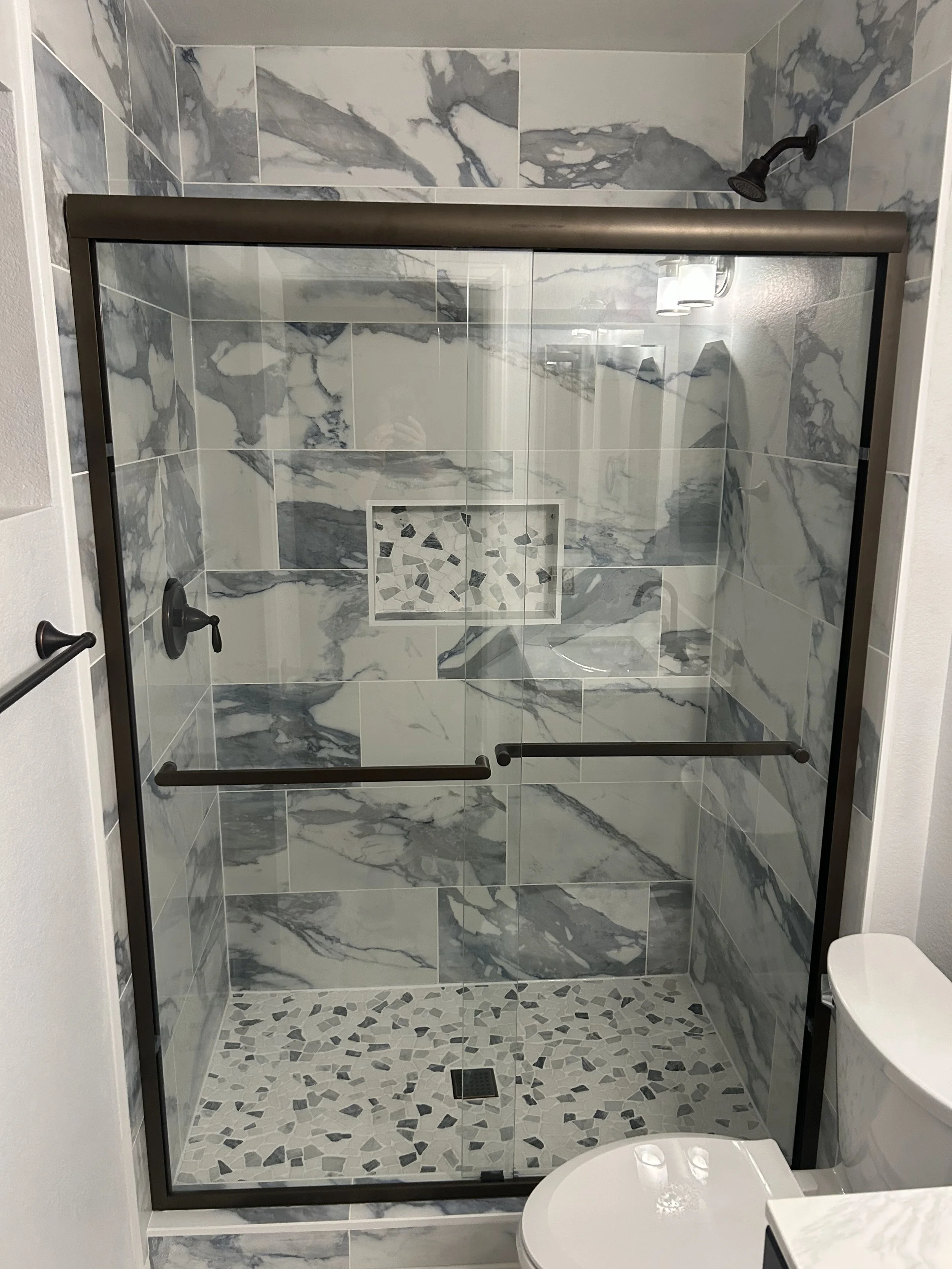 Shower tile installation in a guest bathroom.