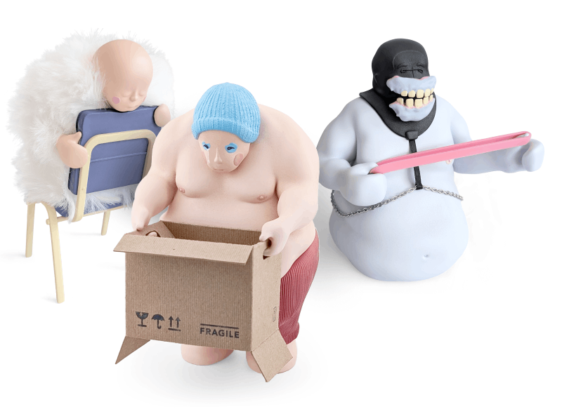 Three whimsical plush toys: a baby doll with a fluffy white hat sitting on a chair, a muscular man with a blue hat opening a cardboard box labeled 'FRAGILE', and a smiling figure with a black skull face wearing a white outfit, holding a pink tray.