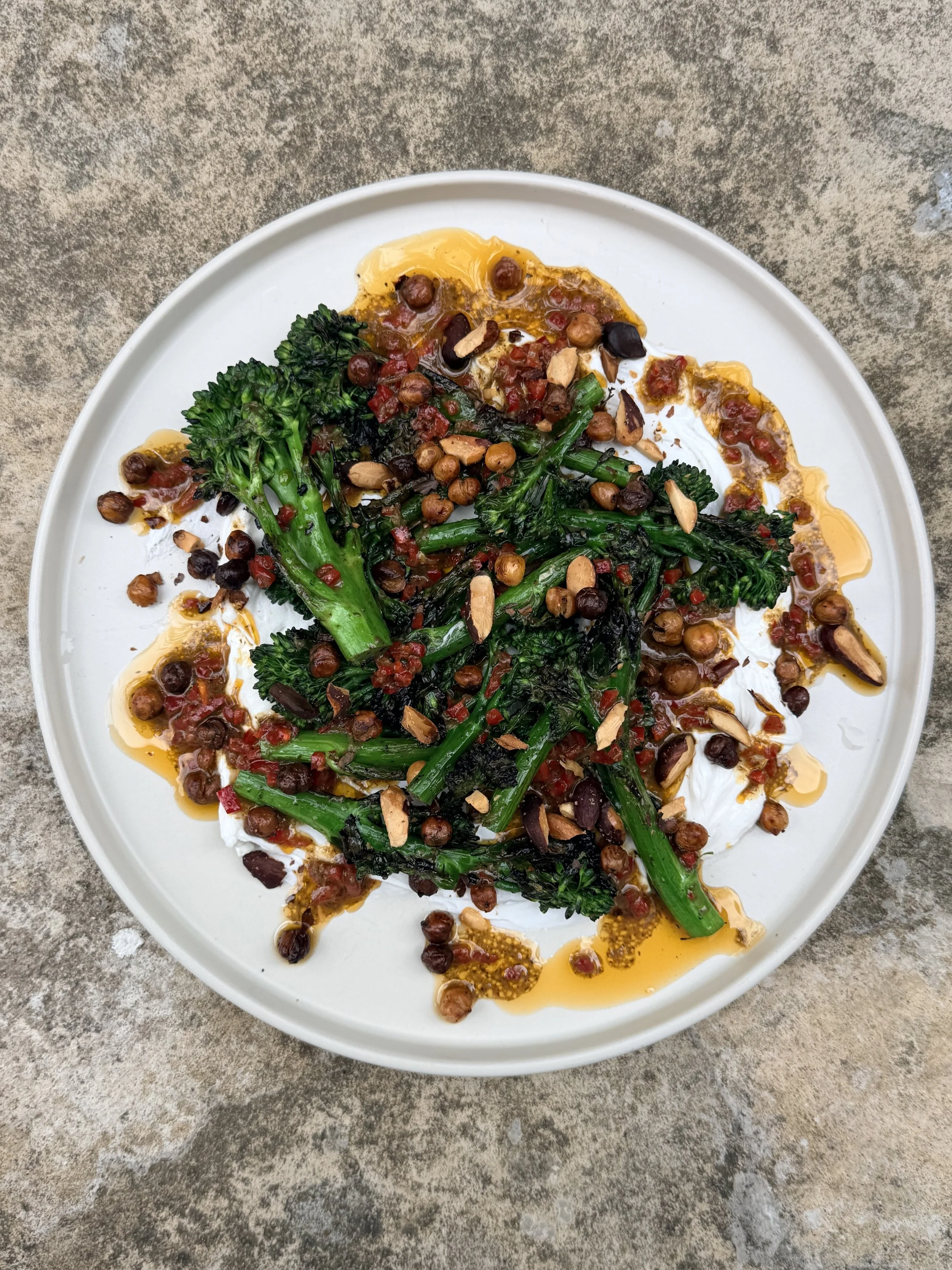 Charred broccoli, labneh, crispy chickpeas, herbs, chilli oil and almonds